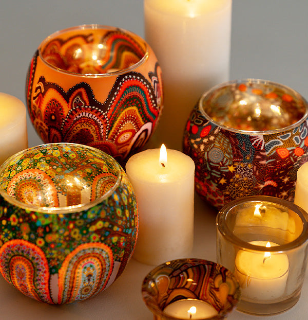 candle holders Australia loves with Aboriginal designs and glowing flames