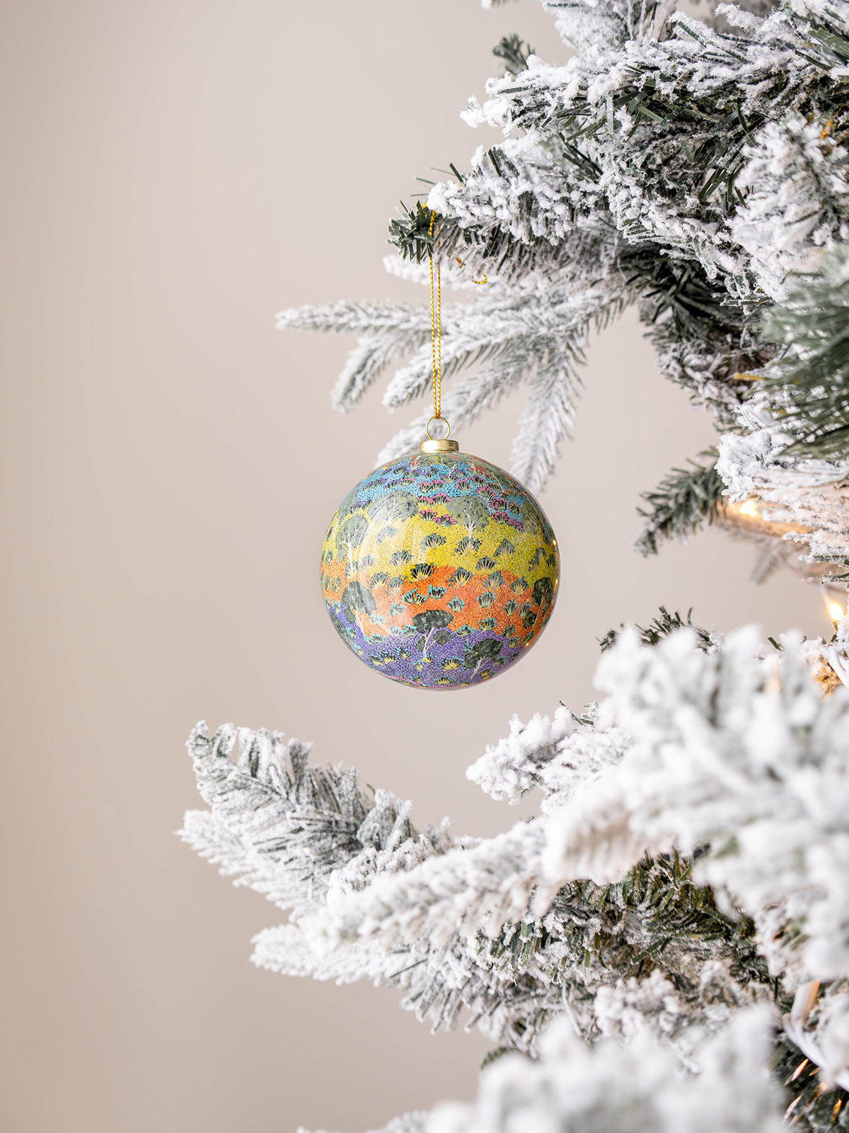 Australian Christmas bauble haning on tree with Aboriginal design