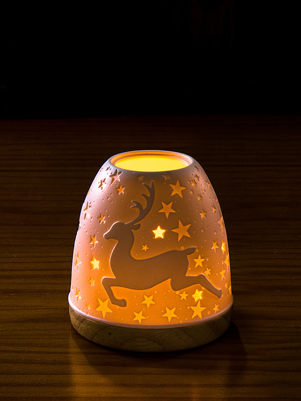 Reindeer Candle Holder Lantern glowing from Koh Living